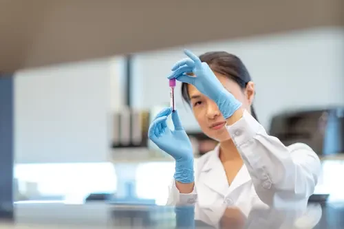 Haematologist analysing a blood sample in the lab