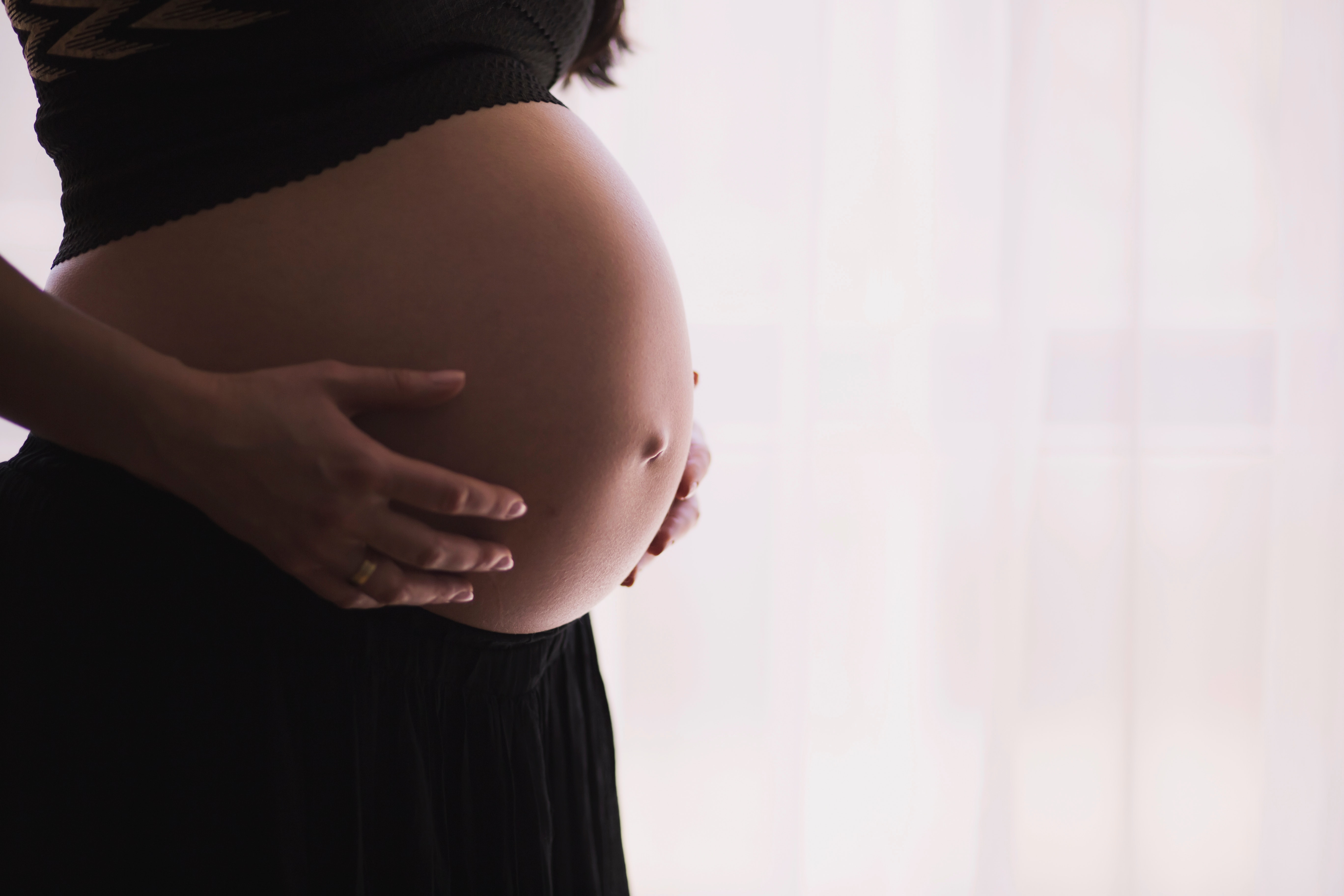 A pregnant woman measures her blood pressure and writes the results in a notebook